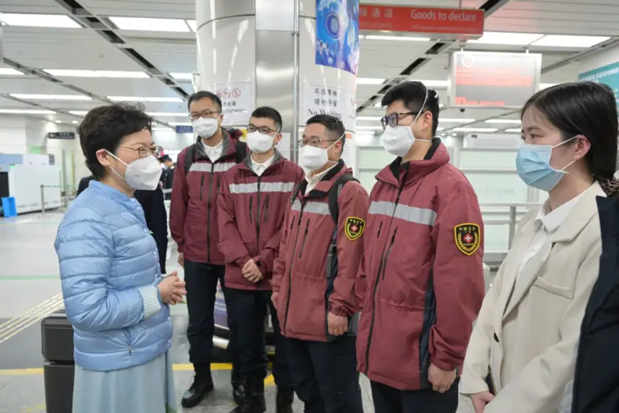 Carrie Lam (left), chief executive of the Hong Kong Special Administrative Region (HKSAR), welcomes and talks with experts and technicians from the Chinese mainland, who come to help Hong Kong with the fight against the COVID-19 pandemic, at the Shenzhen Bay Port, a port of entry and exit between Hong Kong and the Chinese mainland, Feb. 17. (Photo/news.gov.hk)
