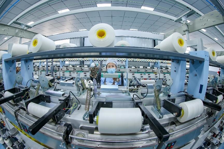 A woman works at a workshop of a special textile company in Daying Economic Development Zone in southwest China's Sichuan province, March 4, 2022. (Photo by Liu Changsong/People's Daily Online)