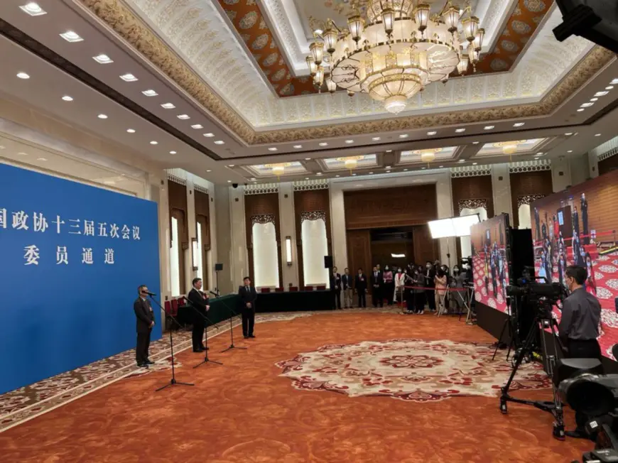 Members of the 13th National Committee of the Chinese People's Political Consultative Conference (CPPCC) are interviewed via video link ahead of the opening of the fifth session of the 13th CPPCC National Committee at the Great Hall of the People in Beijing, March 4. (Photo by Wang Hui/People's Daily)