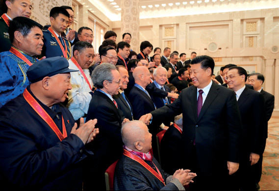 Chinese President Xi Jinping, also general secretary of the Communist Party of China (CPC) Central Committee and chairman of the Central Military Commission, shakes hands with Robert Lawrence Kuhn, chairman of the Kuhn Foundation, who was awarded a China reform friendship medal, after the conclusion of a grand gathering held at the Great Hall of the People in Beijing to celebrate the 40th anniversary of China’s reform and opening-up on Dec. 18, 2018. Chinese President Xi Jinping, also general secretary of the Communist Party of China (CPC) Central Committee and chairman of the Central Military Commission, shakes hands with Robert Lawrence Kuhn, chairman of the Kuhn Foundation, who was awarded a China reform friendship medal, after the conclusion of a grand gathering held at the Great Hall of the People in Beijing to celebrate the 40th anniversary of China’s reform and opening-up on Dec. 18, 2018.