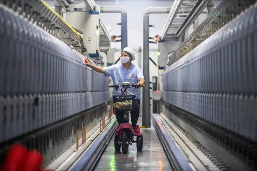A worker carries out patrol inspection on an electric tricycle at a factory of Zhejiang Wanzhou Holding Group Co., Ltd. in Lanxi city, east China’s Zhejiang province, Nov. 29, 2021. (Photo by Hu Xiaofei/People’s Daily Online)