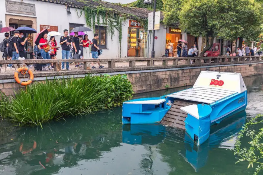 An unmanned cleaning boat is working in a river course in Suzhou, east China's Jiangsu province, July 31, 2021. (Photo by Zhang Feng/People's Daily Online)