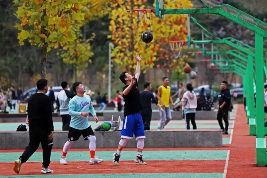 Photo shows people playing basketball at a sports center in Pengshui Miao and Tujia autonomous county, southwest China's Chongqing municipality. (Photo by Zhao Yong/People's Daily)