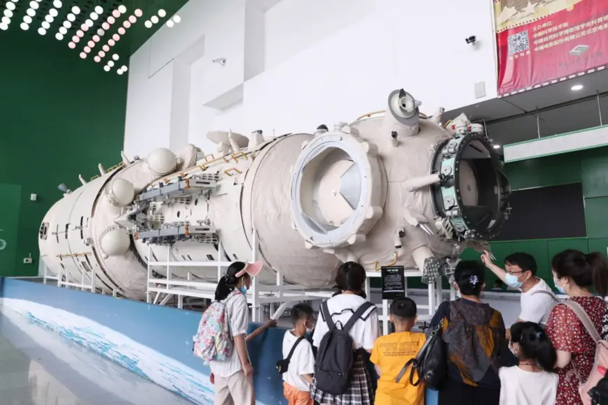 Parents and children watch a life-size model of the Tianhe core module of China’s space station at the China Science and Technology Museum in Beijing, June 30, 2021. (Photo by Chen Xiaogen/ People's Daily Online)
