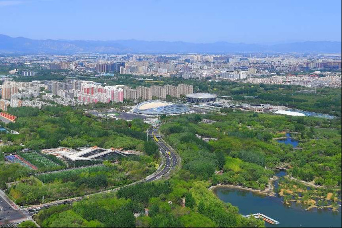 Photo taken on April 22, 2022 shows the National Speed Skating Oval surrounded by trees in Beijing. (Photo by Sun Lijun/People's Daily Online)