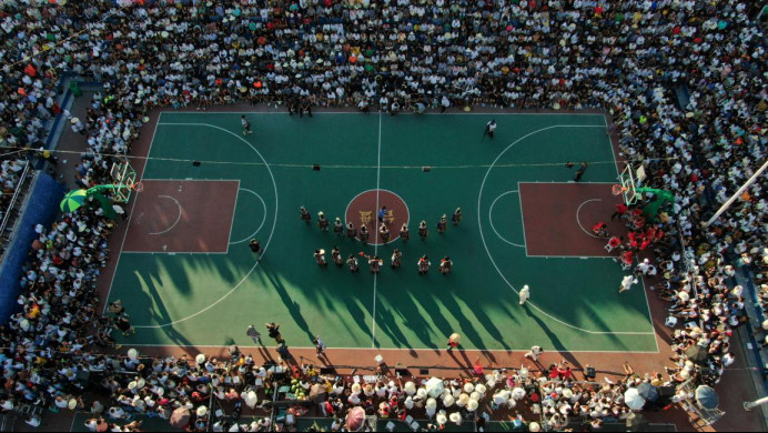 Halftime performance is staged during a basketball game held in Taipan village, Taipan township, Taijiang county, Qiandongnan Miao and Dong autonomous prefecture, southwest China's Guizhou province, Aug. 9, 2022. (Photo by Cai Xingwen/People's Daily Online)