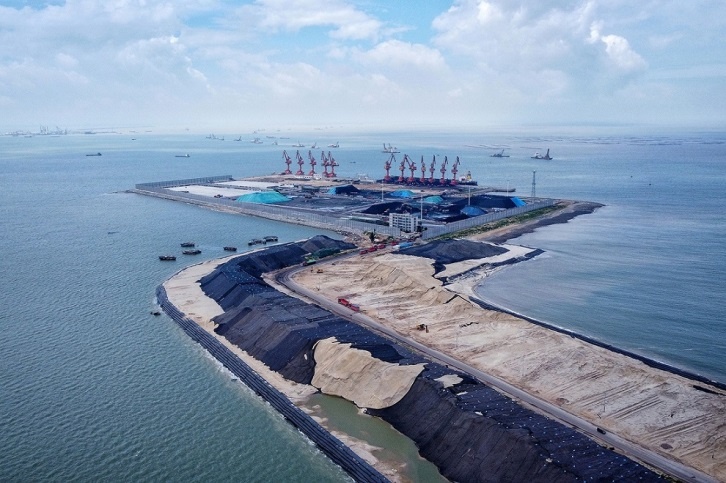 Photo taken in June 2021 shows an expansion project for the east channel of Qinzhou Port, south China's Guangxi Zhuang autonomous region. Upon completion, the port will have a two-way route that stretches 23.23 kilometers and is navigable to 100,000-ton containerships. (Photo by Chen Xuehua/People's Daily Online)