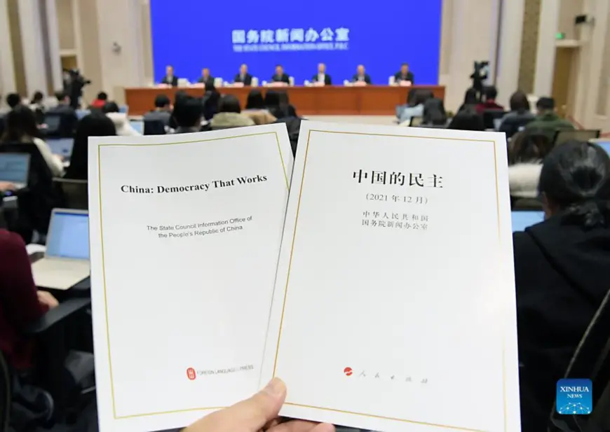 Photo shows the Chinese and English editions of the white paper titled "China: Democracy That Works" at a press conference held by the State Council Information Office in Beijing, capital of China, Dec. 4, 2021. (Xinhua/Li He)