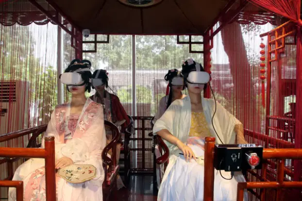 Tourists in traditional Chinese costumes visit the Humble Administrator's Garden, a UNESCO World Heritage Site in Suzhou, east China's Jiangsu province, via a VR program, July 26, 2022. (Photo by Wang Jiankang/People's Daily Online)