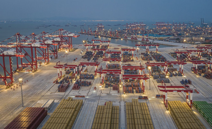 The fully automated terminal of Nansha port starts operation in Guangzhou, capital of south China's Guangdong province, in July 2022. In this picture, bridge cranes, rail-mounted gantry cranes and automated guide vehicles work in an orderly manner at the terminal under an intelligent control system . (Photo by Qiu Xinsheng/People's Daily Online)