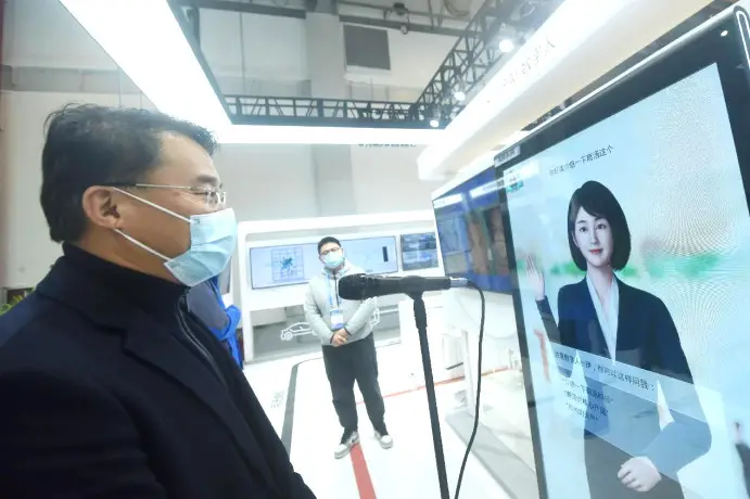 A visitor talks with an artificial intelligence-enabled virtual figure at the first Global Digital Trade Expo held in Hangzhou, east China's Zhejiang province, Dec. 12, 2022. (Photo by Long Wei/People's Daily Online)