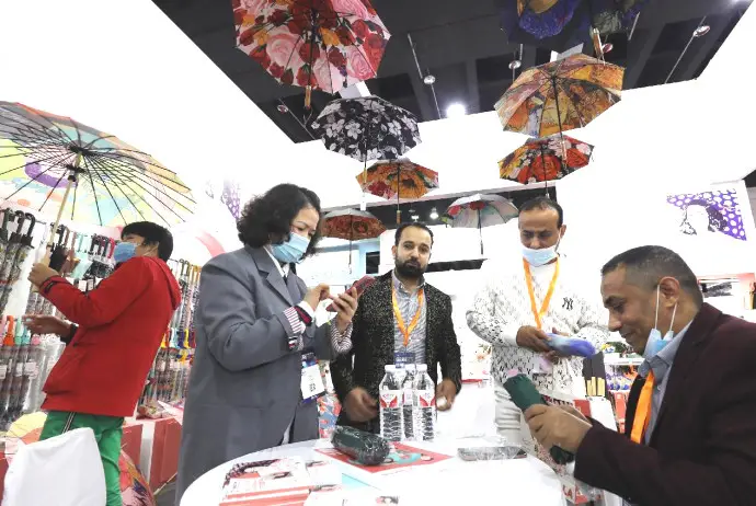 Foreigners buy umbrellas at the Yiwu International Expo Center, Yiwu, east China's Zhejiang province, Nov. 24, 2022. (Photo by Gong Xianming/People's Daily Online)