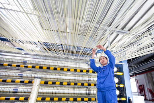 An employee of the Xining branch of Zhongfu Shenying, a leading Chinese carbon fiber manufacturer, works in a workshop. (Photo by He Yingli)