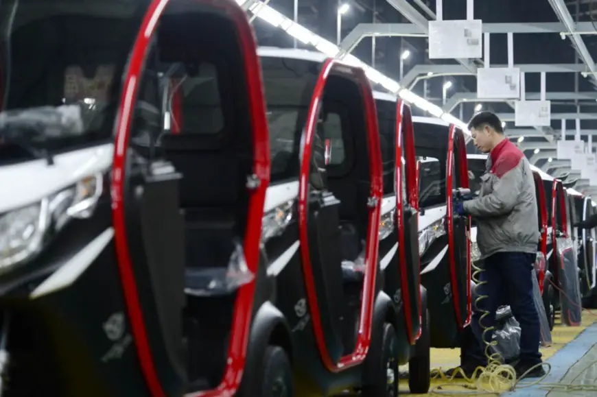 Electric vehicles are assembled in an manufacturing base in Runan county, Zhumadian, central China's Henan province, Feb. 8, 2023. (Photo by Sun Kai/People's Daily Online)