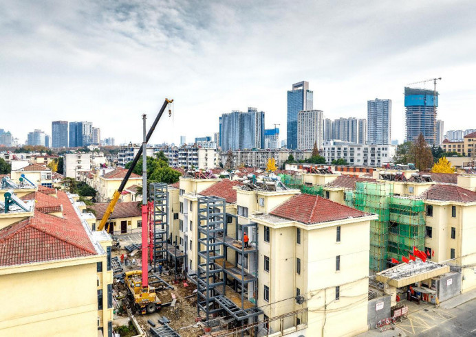 Elevators are installed for an old residential community in Hefei, capital of east China's Anhui province, Dec. 11, 2022. (Photo by Luo Xianyang/People's Daily Online)