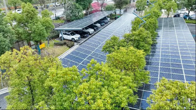 Photo taken on Feb. 24, 2023 shows a parking lot covered by solar photovoltaic (PV) panels in Nanxun district, Huzhou, east China's Zhejiang province. The panels not only offer shelter for vehicles, but also power the lot by converting light energy into electricity. (Photo by Lu Xiaoyao/People's Daily Online)