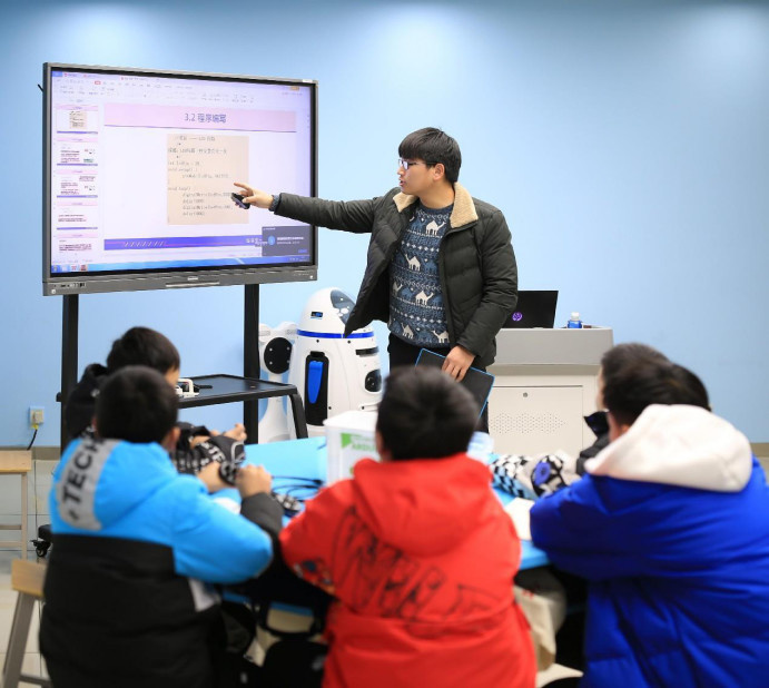 A teacher gives programming lesson to children at a youth activity center in Fanchang district, Wuhu city, east China's Anhui province. (Photo by Cheng Jian/People's Daily Online)