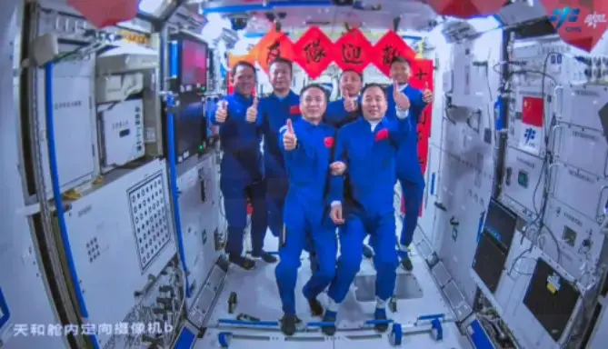 This screen image shows the Shenzhou-15 and Shenzhou-16 crew taking group pictures inside the core module Tianhe of China's space station. (Photo from the official website of China Manned Space)