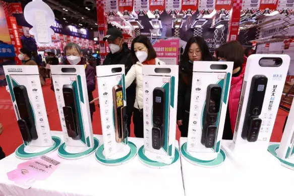 Smart door locks are exhibited at the Home China Expo in Beijing, Feb. 18, 2023. (Photo by Chen Xiaogen/People's Daily Online)