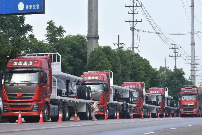 Fifty trucks manufactured by Hunan Jinsong Automobile are about to be shipped to Tanzania from Jiahe county, Chenzhou, central China's Hunan province, May 17, 2022. (Photo by Huang Chuntao/People's Daily Online)