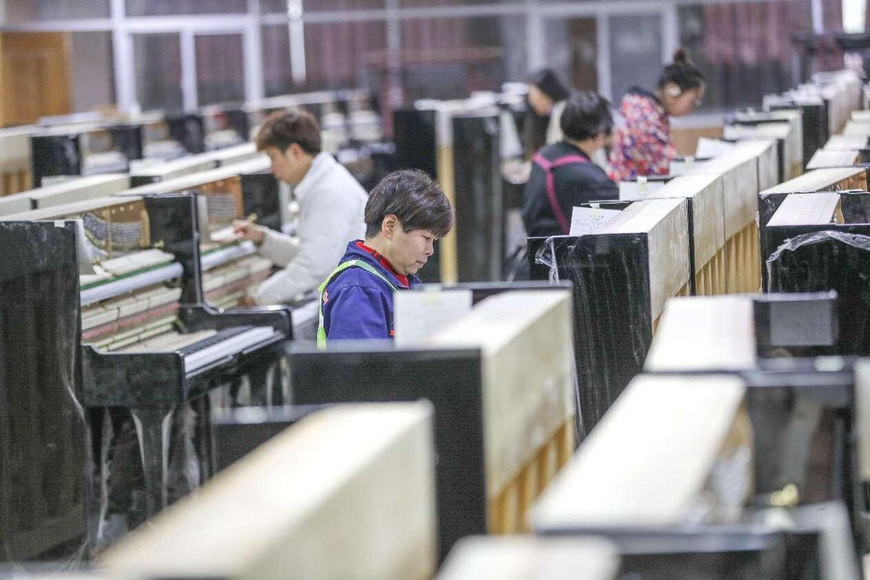 Workers assemble pianos on the production line of Zhejiang Yueyun Piano Co., Luoshe town of Deqing county, Huzhou, east China's Zhejiang province. (Photo by Wang Shucheng/People's Daily Online) Workers assemble pianos on the production line of Zhejiang Yueyun Piano Co., Luoshe town of Deqing county, Huzhou, east China's Zhejiang province. (Photo by Wang Shucheng/People's Daily Online)