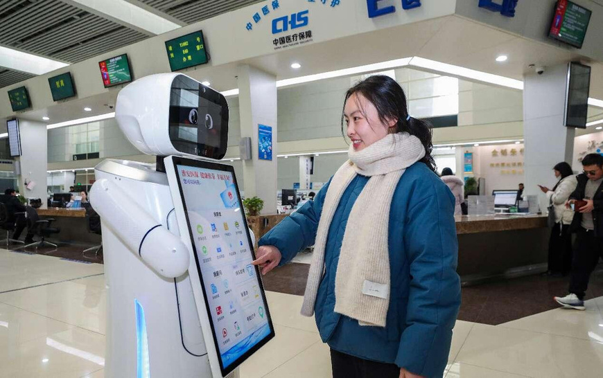 A citizen uses an AI-enabled robot to process medical insurance services at the municipal service center in Huai'an, east China's Jiangsu province. (Photo by Zhao Qirui/People's Daily Online) A citizen uses an AI-enabled robot to process medical insurance services at the municipal service center in Huai'an, east China's Jiangsu province. (Photo by Zhao Qirui/People's Daily Online)