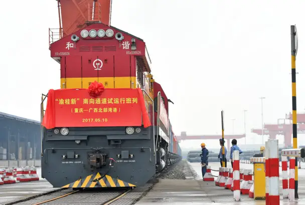 May 10, 2017, the first pilot freight train for new sea-rail transportation route linking southwest China's Chongqing Municipality and Singapore was going to set off with 21 rails cars loaded with containers. It was expected to arrive at Qinzhou Port in south China's Guangxi Zhuang Autonomous Region in two days and stretch south to Singapore and other countries of Southeast Asia. In the picture, workers are doing tests before its departure. Photo : Xinhua News Agency