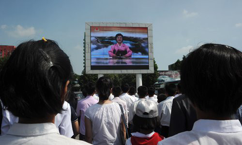 Pyongyang residents watch TV announcer Ri Chun-hee talk about the successful launch of what North Korea called the intercontinental ballistic missile "Hwasong-14," on a jumbo screen near the Pyongyang Railway Station on Tuesday. Photo: AFP