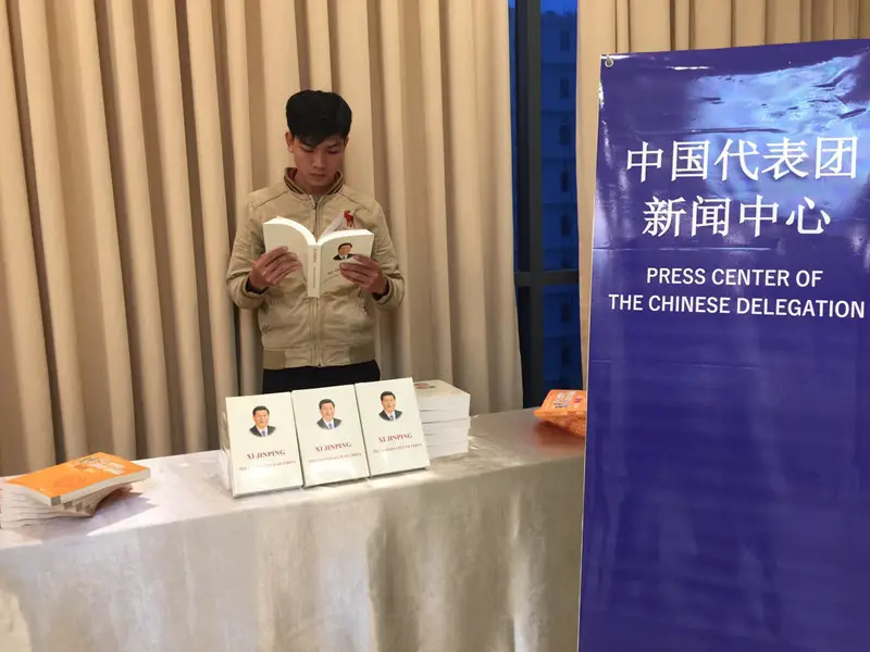 A Vietnamese man reads Chinese President Xi Jinping’s book “The Governance of China” at the press center of Chinese delegation to Da Nang APEC Summit.