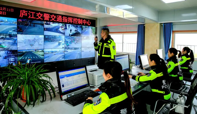 Traffic police of Lujiang county, Anhui province are monitoring and managing traffic by applying new technologies, February 11, 2018. (Photo by Zuo Xuechang from People’s Daily Online)