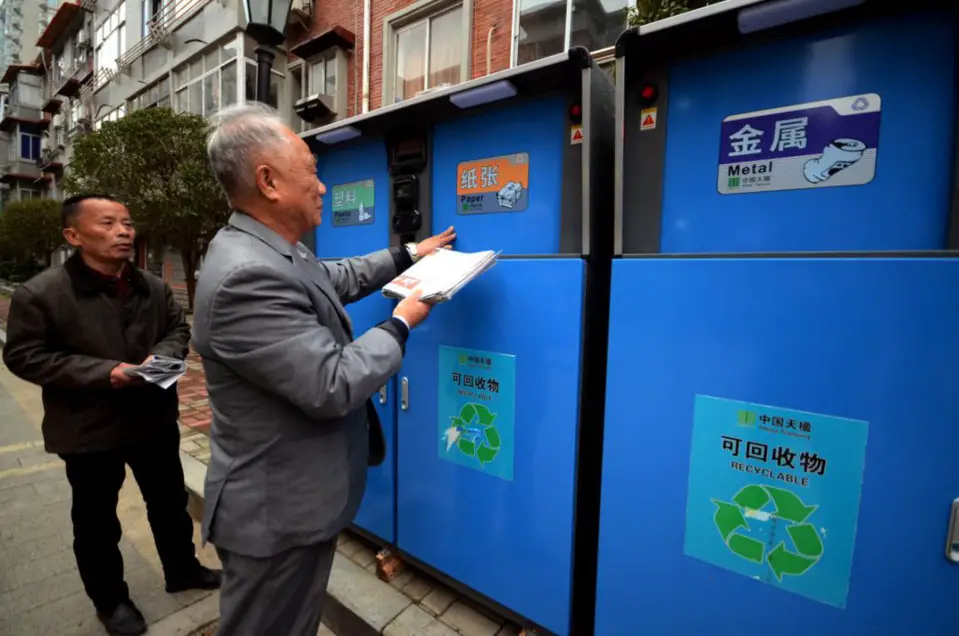 A resident throws rubbish into a garbage sorting can in Nanchang, east China’s Jiangxi province, March 6, 2018. He will receive credits if he throws the trash into the right can, and the credits can be used to buy drinks, tissues and soaps. (Photo from CFP)