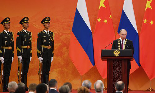 Russian President Vladimir Putin (right) speaks after being presented with the Friendship Medal of the People's Republic of China by Chinese President Xi Jinping at the Great Hall of the People in Beijing on Friday. Photo: IC