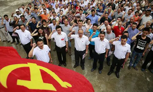 Communist Party of China members review their vows of joining the Party in Hongyan township, Sichuan Province, June 21. Photo: IC