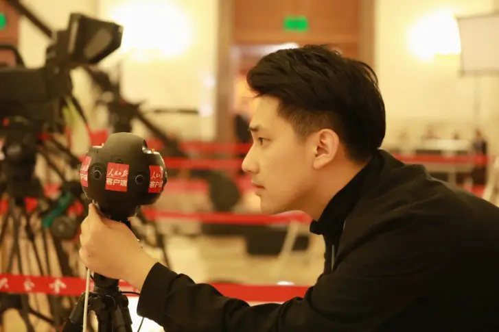 People’s Daily journalist Wang Jingyuan tests a panoramic camera at the Great Hall of the People.