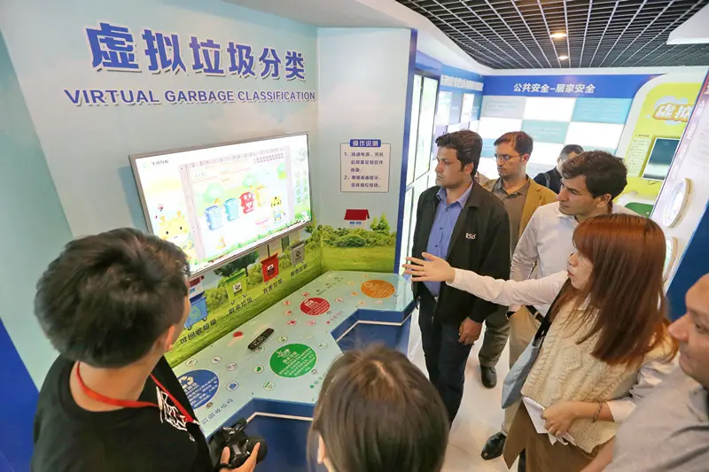 A BRI delegation visits a virtual garbage classification site at a Chinese community science hall, May 9, 2019. (Photo/People’s Daily Online)