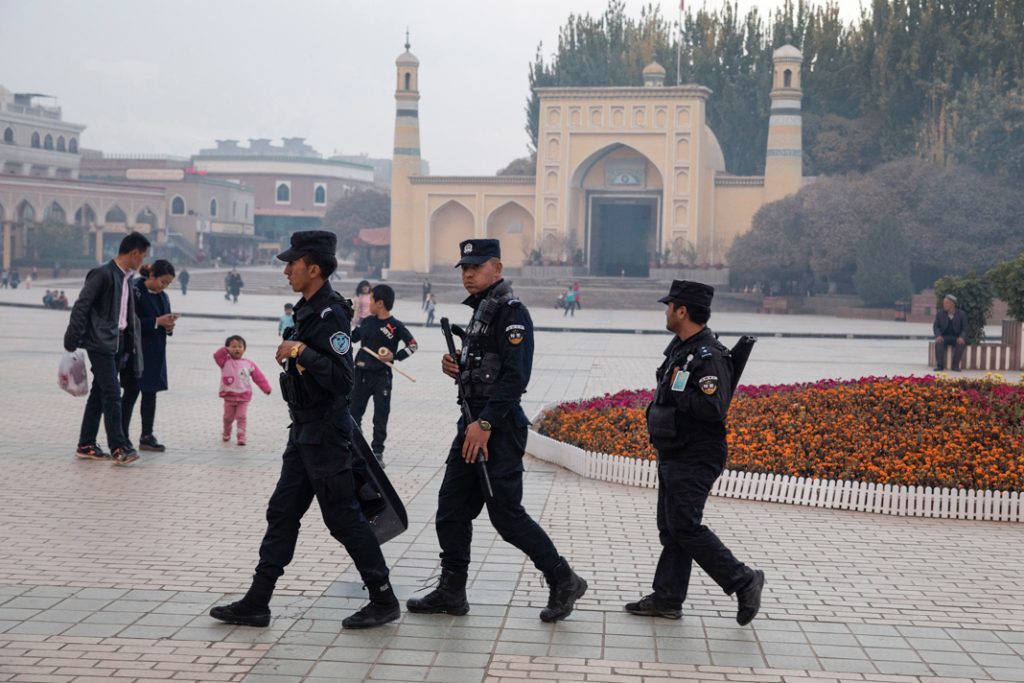 Des forces de sécurité patrouillent près de la mosquée Id Kah, au Xinjiang, en 2017. La Chine a endommagé d’autres mosquées aux alentours. (© Ng Han Guan/AP Images)