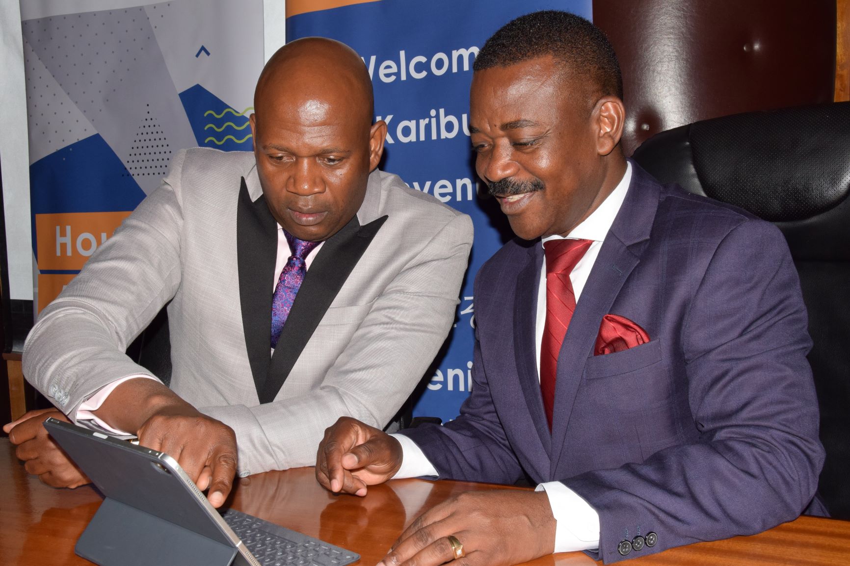Shelter Afrique Managing Director Andrew Chimphondah (left) explains financials results to Shelter Afrique Chairman Nghidinua Daniel when the Company released its 2019 half year result last month.