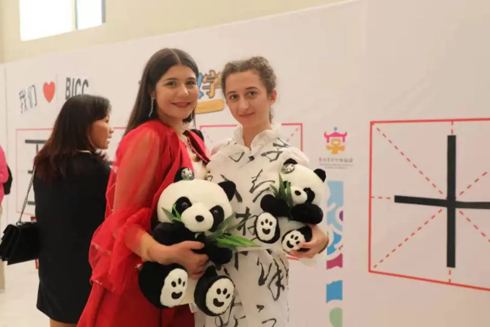 Greek citizens hold panda toys as they pose for a photo at a Chinese characters exhibition in Athens, Greece. (Photo by Hua Fang from People's Daily).