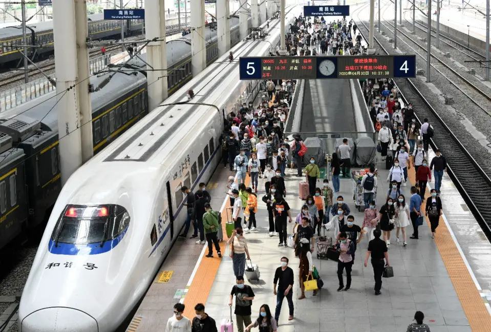 Passengers take bullet trains at Nanchang Railway Station, east China’s Jiangxi province, April 30. Photo by Hu Guolin, People’s Daily Online