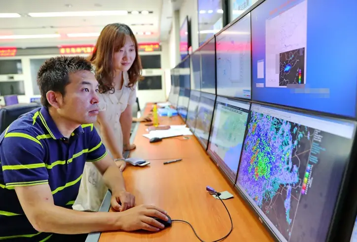 On July 17, an engineer at the meteorological bureau of Qinhuangdao, North China’s Hebei Province, monitors meteorological data to help prevent flood. Photo by Cao Jianxiong/People’s Daily Online