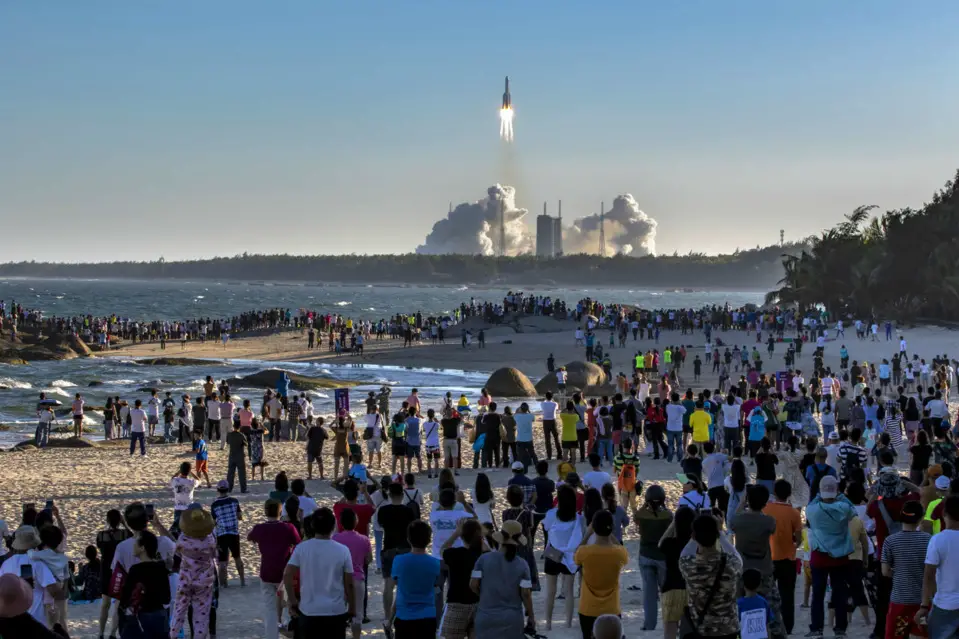 Visitors watch the launching of Long March-5B carrier rocket near the Wenchang Space Launch Center, south China’s Hainan province, May 5. (Photo by Chen Yun/People’s Daily Online)