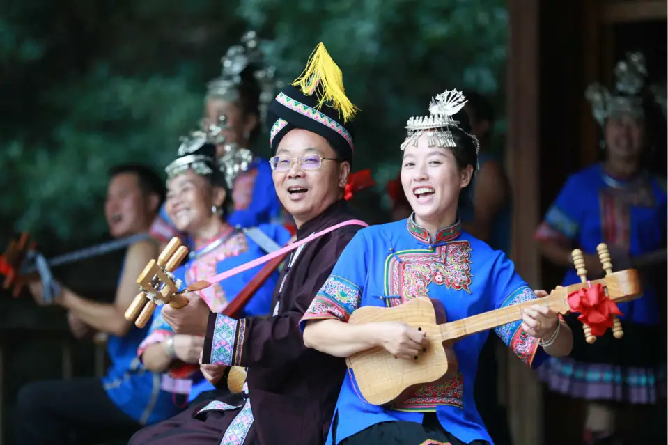 People learn to play pipa, one of the most popular traditional Chinese instruments, in Tongdao Dong autonomous county, central China's Hunan province, Aug. 15. The county has introduced intangible cultural heritage programs of Dong music and instruments to poverty alleviation activities, which not only enriches the leisure activities of the people, but also contributes to the inheritance of intangible cultural heritage. Photo by Liu Qiang/People's Daily Online