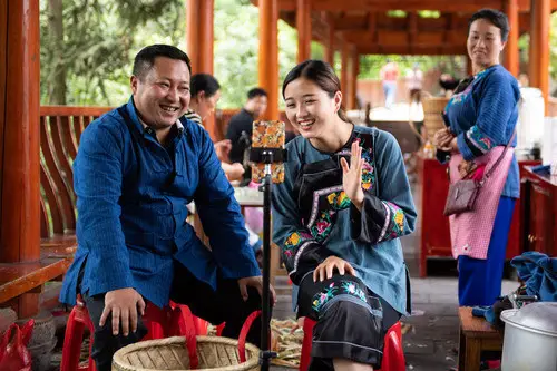 Ma Huihuang (L), head of a work team for poverty alleviation in Shibadong village, Huayuan county in Xiangxi Tujia and Miao autonomous prefecture of Hunan, joins a livestream show hosted by Shi Linjiao to sell local speciaties, May 15. (Photo by Chen Sihan/Xinhua News Agency)