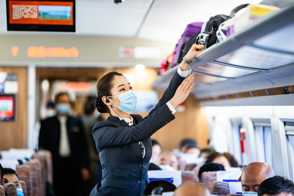 A crew member works on the high-speed train D4355 bound for Yinchuan, northwest China’s Ningxia Hui autonomous region, Dec. 26, 2020. (Photo by Liu Xiang/People’s Daily Online)