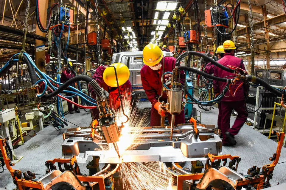 Employees work in a welding workshop of an automaker in Qingzhou, east China's Shandong Province, Feb. 28, 2021. (Photo by Wang Jilin/People's Daily Online)