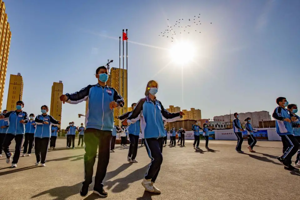 Students of a high school in Turpan, northwest China’s Xinjiang Uygur autonomous region, take a P.E. class at the school’s track and field stadium, which was built with the assistance of central China’s Hunan province, Oct. 20, 2020. (Photo by Cai Zengle/People’s Daily Online).