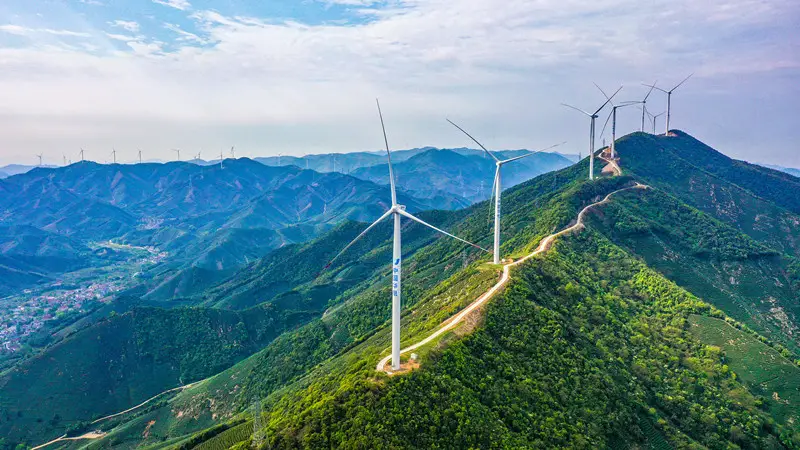 Photo taken on April 13, 2021, shows a row of wind turbines set up on the mountains in Heping town, Changxing county, Huzhou city, east China's Zhejiang province. (Photo by Wu Zheng/People's Daily Online)