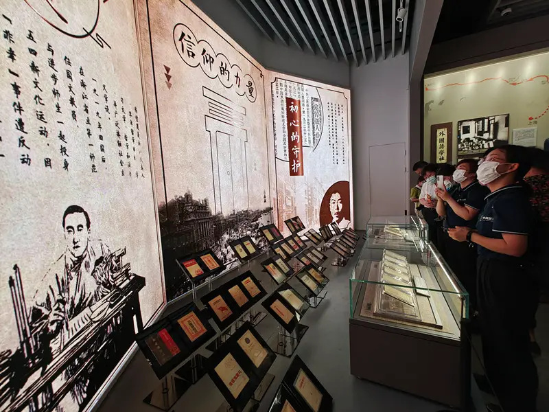 Citizens watch copies of The Communist Manifesto exhibited at the memorial of the 1st National Congress of the Communist Party of China (CPC) in Shanghai, June 22, 2021. (Photo by Wang Chu/People’s Daily Online)