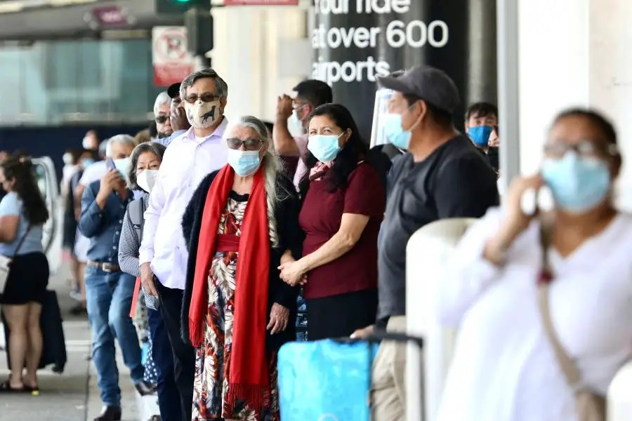 Travelers with face masks are seen at the Los Angeles International Airport in Los Angeles, the United States, July 18, 2021. (Xinhua)