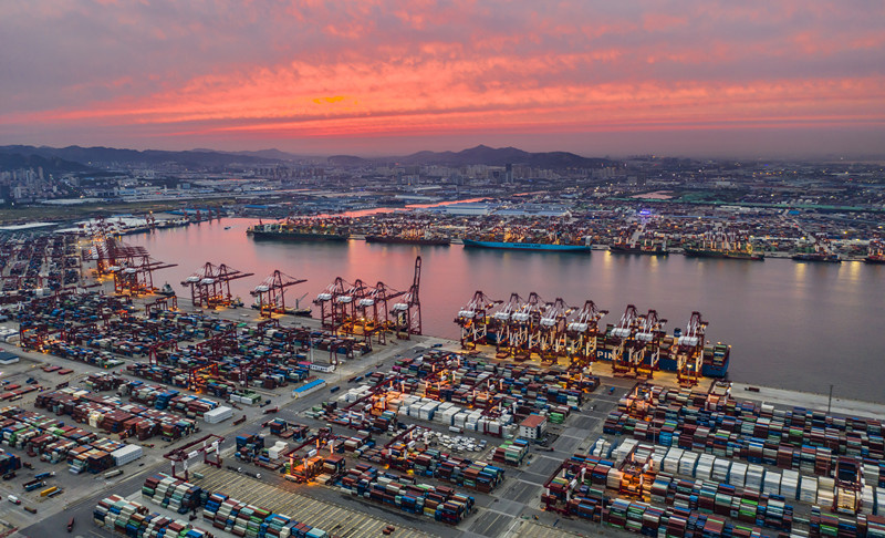 Photo shows a busy container terminal of the Qianwan area of Qingdao Port in Qingdao, east China’s Shandong province, under the sunset glow, August 27, 2021. (Photo by Wang Hua/People’s Daily Online) Photo shows a busy container terminal of the Qianwan area of Qingdao Port in Qingdao, east China’s Shandong province, under the sunset glow, August 27, 2021. (Photo by Wang Hua/People’s Daily Online)